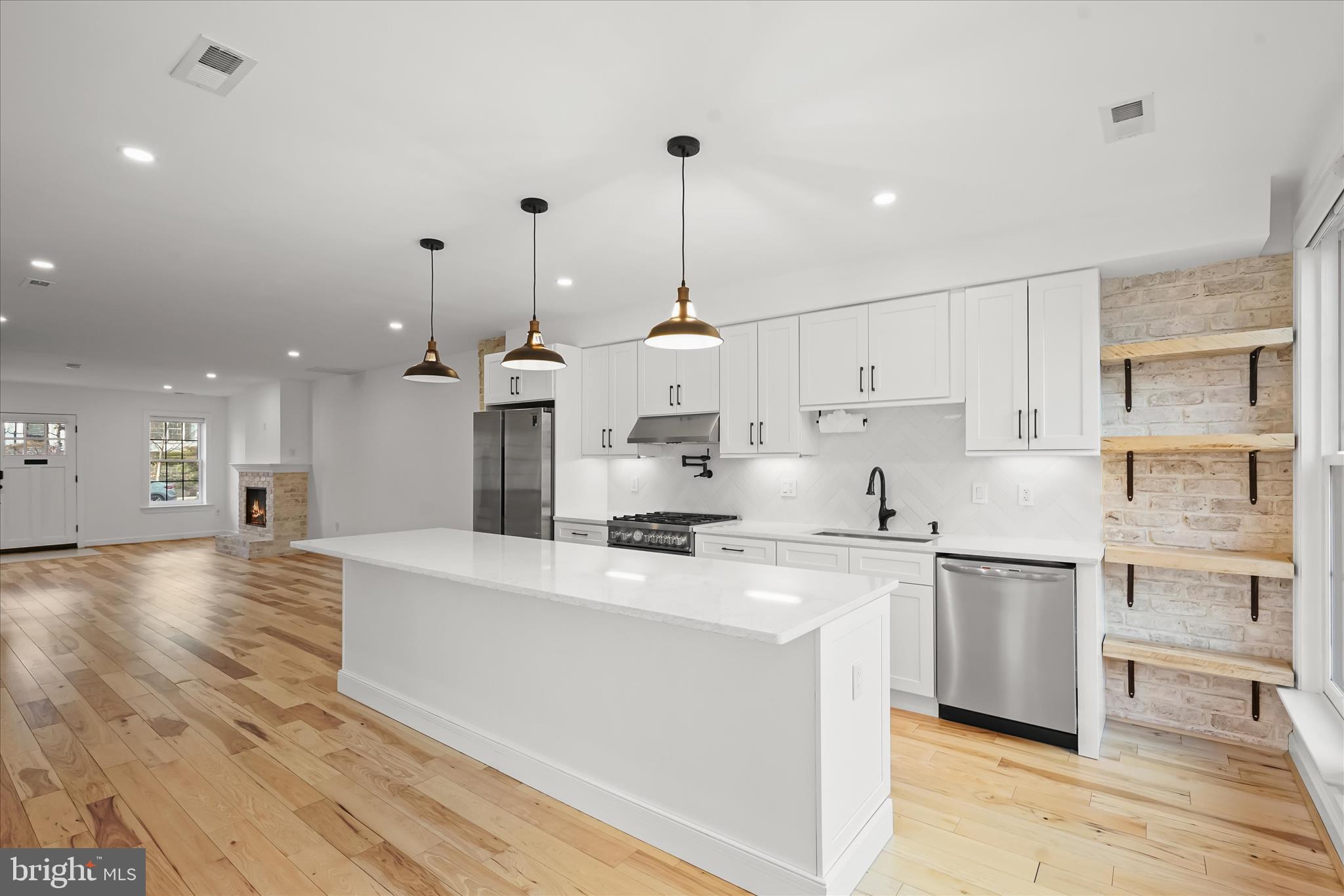 3626 T Street Northwest Washington, DC 20007 - Photo 10 of 61 a large kitchen with stainless steel appliances kitchen island granite countertop a sink and cabinets