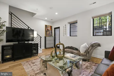a dining room with furniture and wooden floor