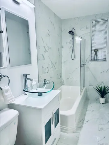 a bathroom with a sink a toilet and bathtub