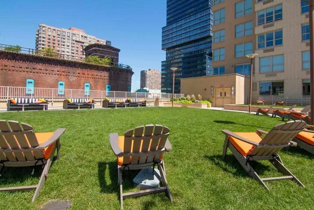 a view of a patio with couches table and chairs and potted plants