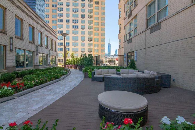 a room with furniture pool table wooden floor and windows