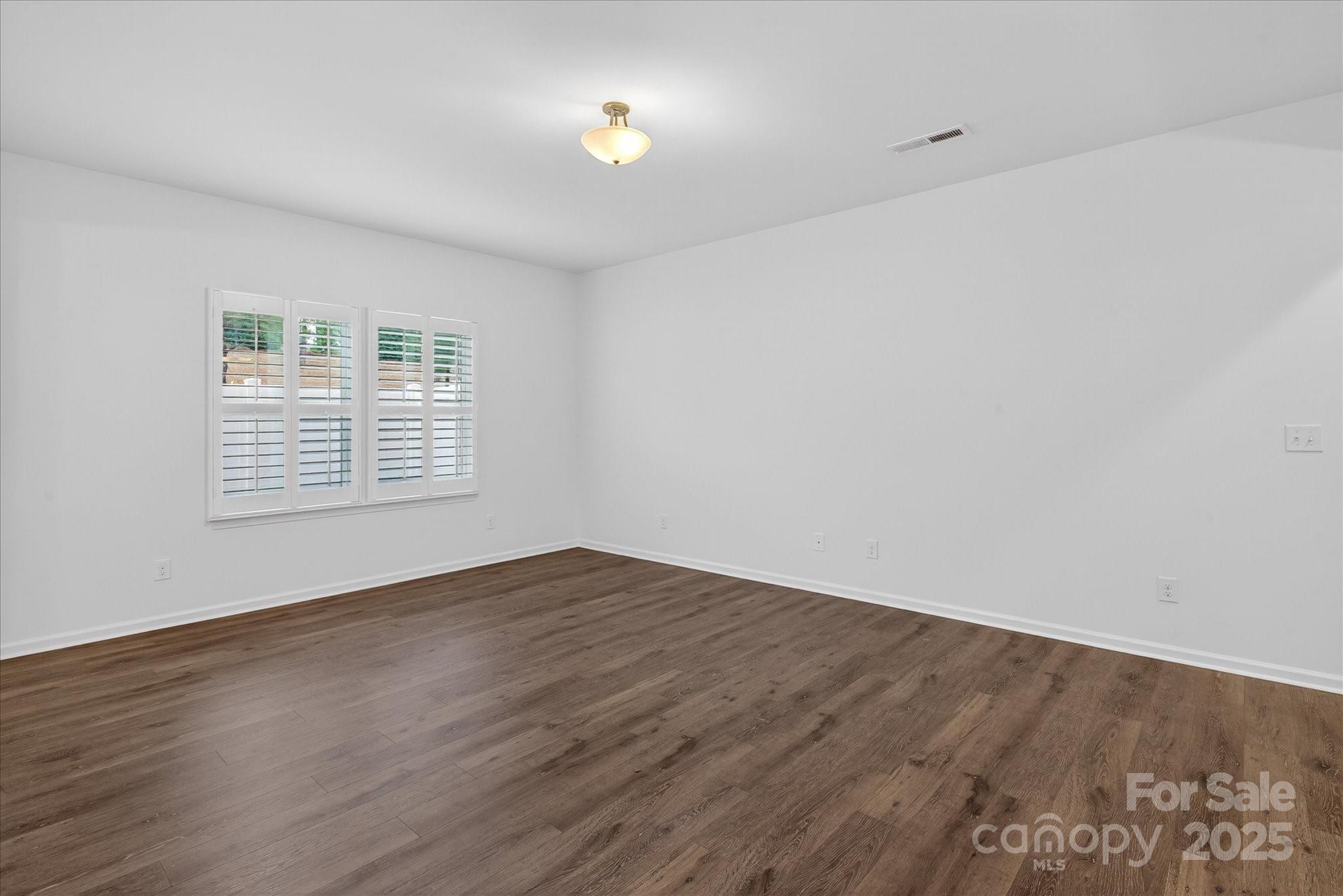 7481 Hartsfield Drive Lancaster, SC 29720 - Photo 16 of 47 wooden floor in an empty room with a window