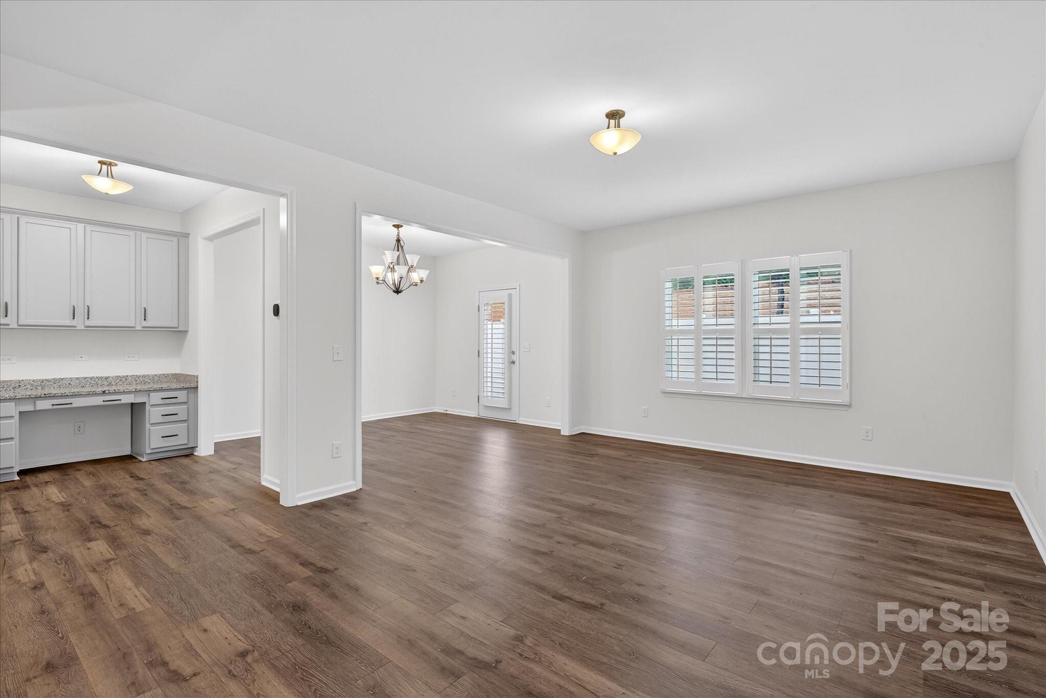 7481 Hartsfield Drive Lancaster, SC 29720 - Photo 17 of 47 a view of an empty room with a window and wooden floor