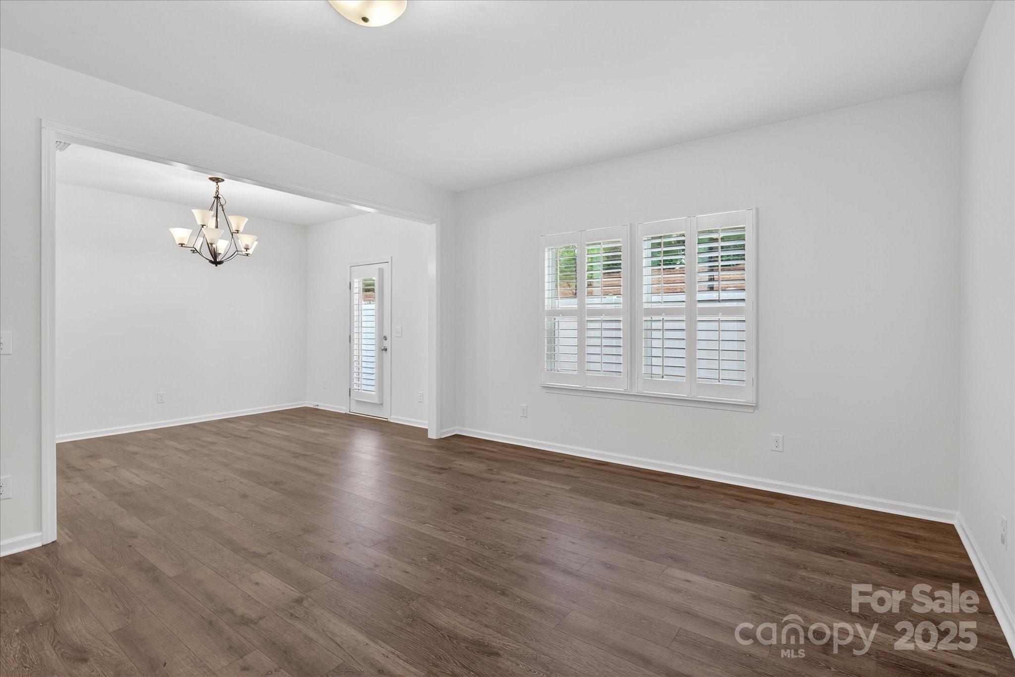 7481 Hartsfield Drive Lancaster, SC 29720 - Photo 18 of 47 a view of an empty room with wooden floor and a window