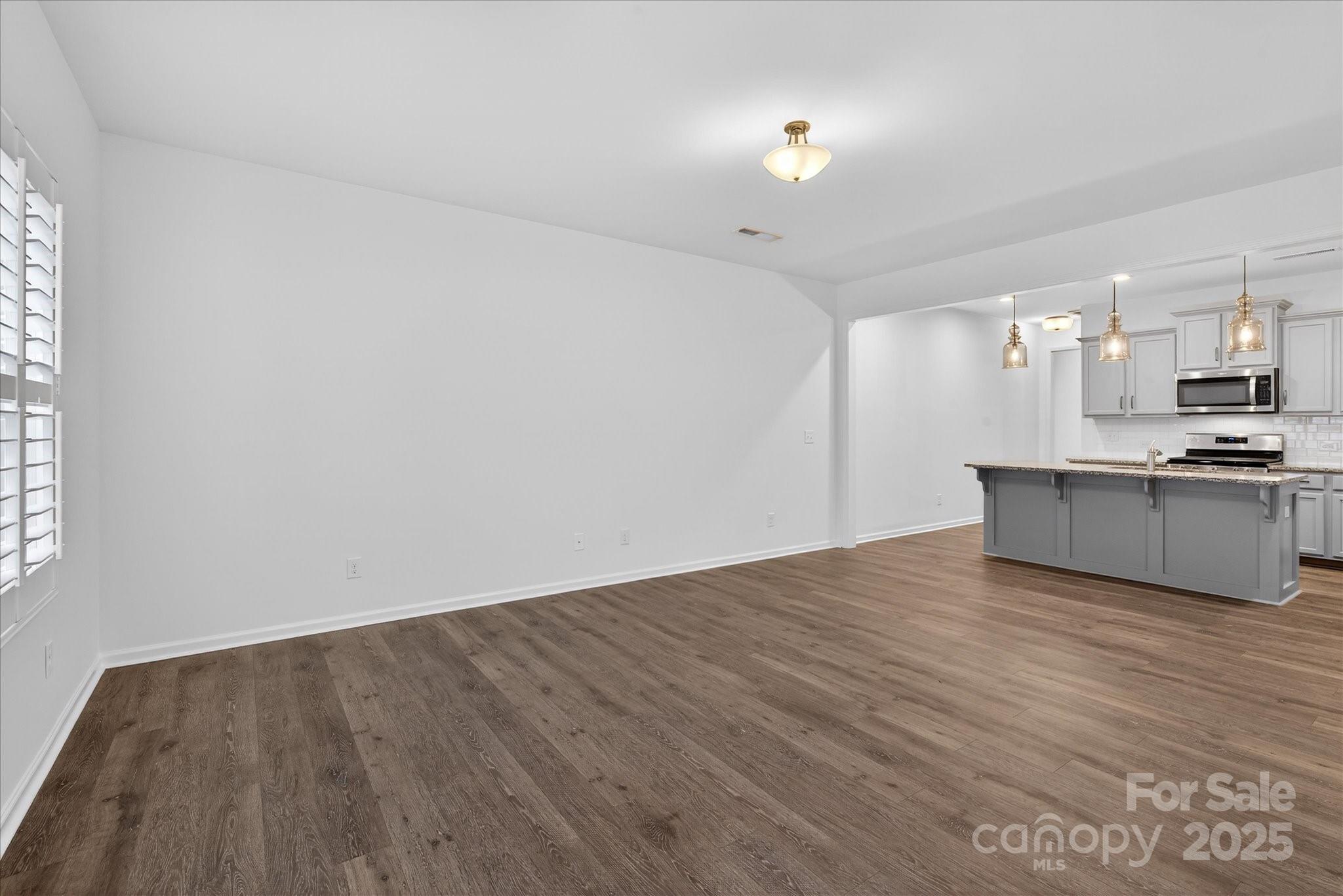7481 Hartsfield Drive Lancaster, SC 29720 - Photo 20 of 47 a view of a kitchen with wooden floor and a sink
