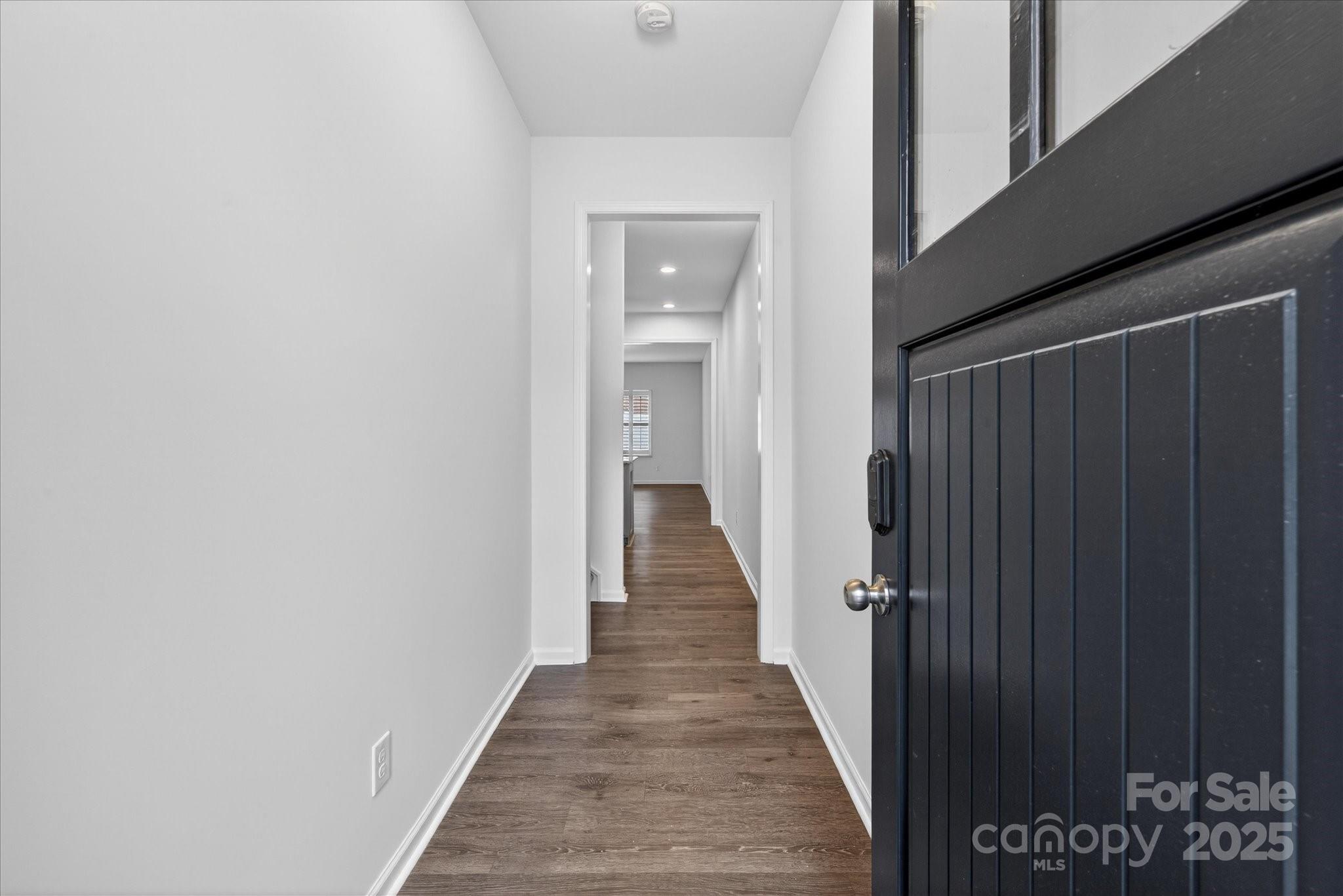 7481 Hartsfield Drive Lancaster, SC 29720 - Photo 21 of 47 a view of a hallway with wooden floor and staircase