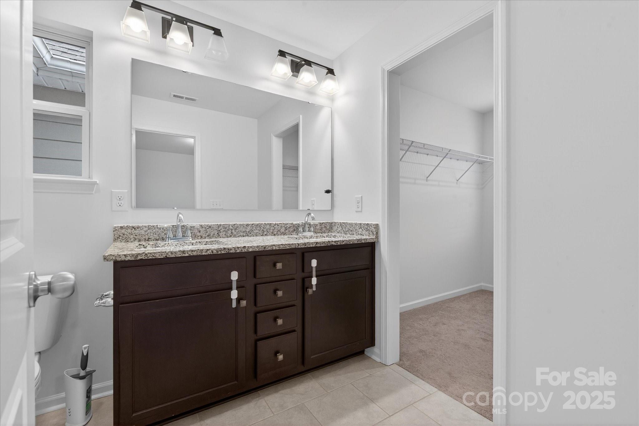 7481 Hartsfield Drive Lancaster, SC 29720 - Photo 26 of 47 a bathroom with a granite countertop sink and a mirror