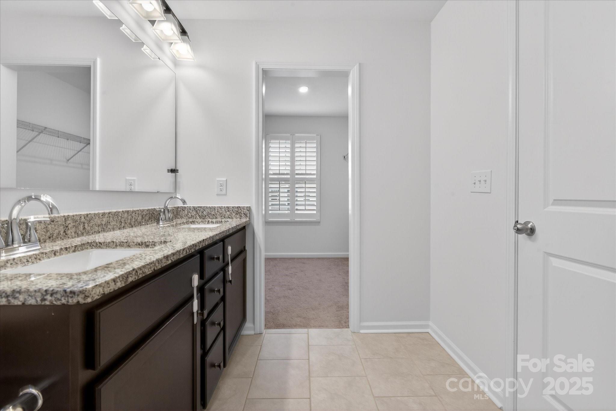 7481 Hartsfield Drive Lancaster, SC 29720 - Photo 28 of 47 a bathroom with a granite countertop sink and a mirror