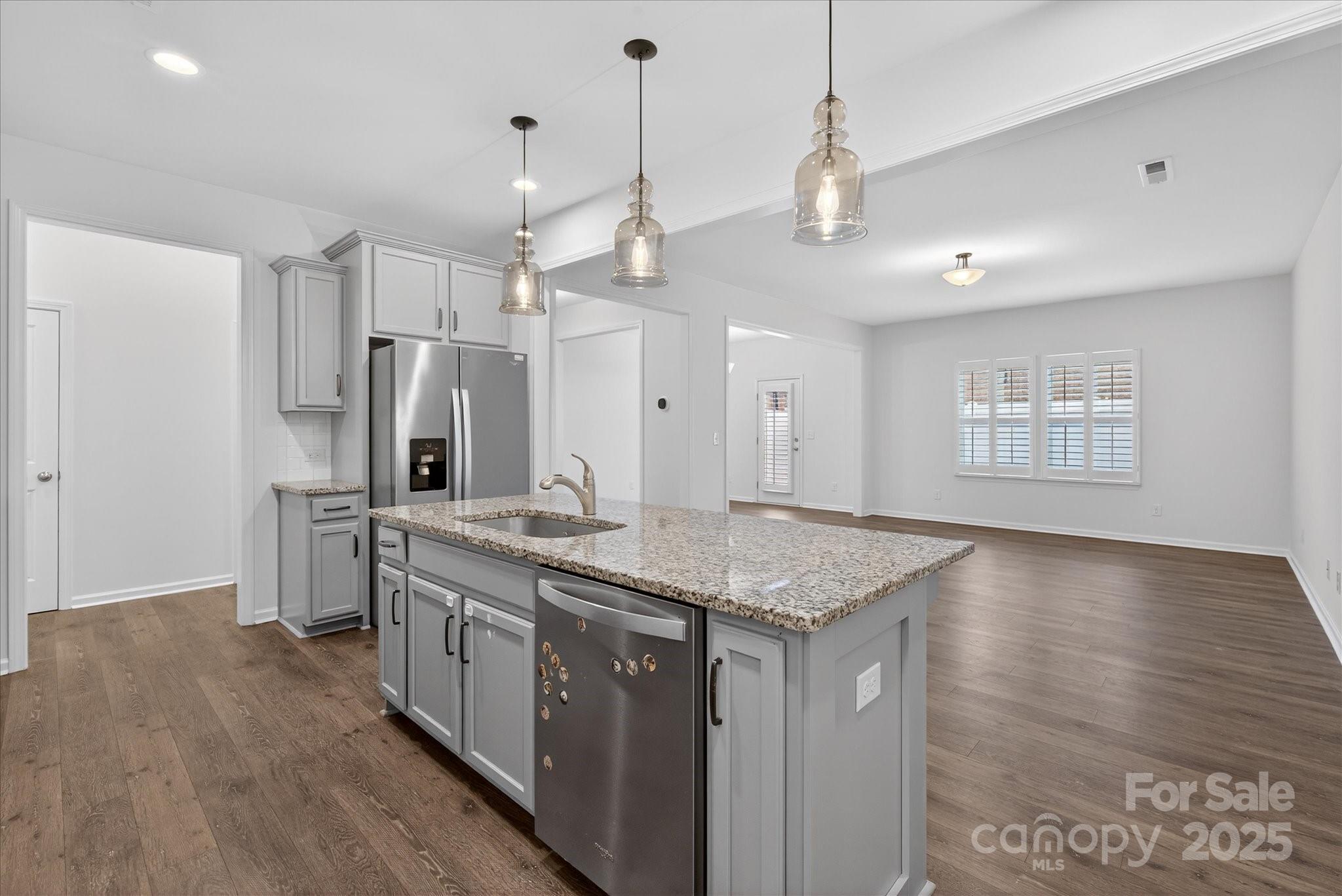 7481 Hartsfield Drive Lancaster, SC 29720 - Photo 4 of 47 a kitchen with stainless steel appliances granite countertop a sink a refrigerator and a stove