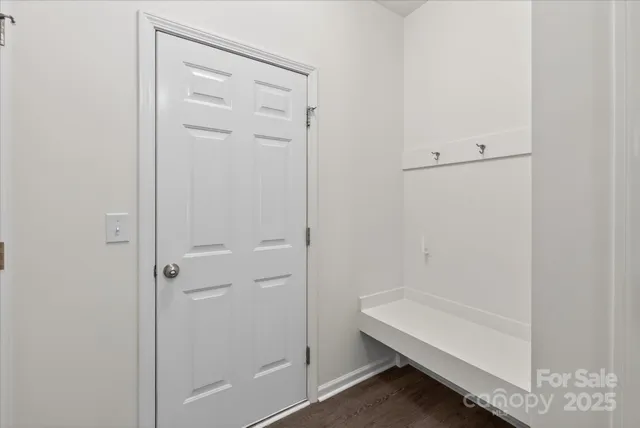 a front view of multi story residential apartment building with yard and sign board