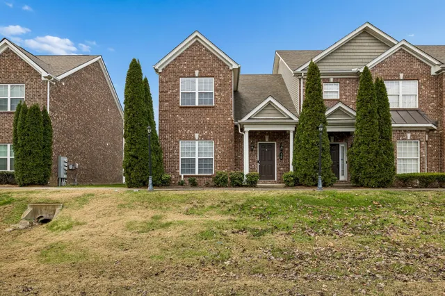 a front view of a house with a yard