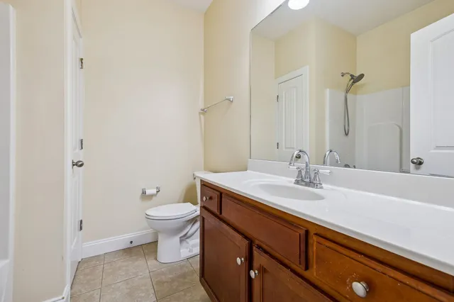a bathroom with a sink a toilet and a mirror