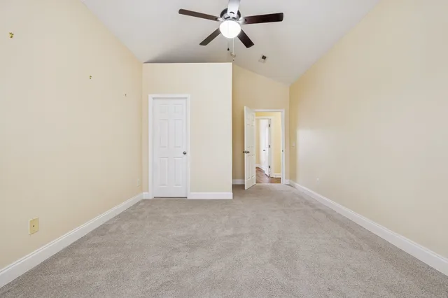 an empty room with closet and windows