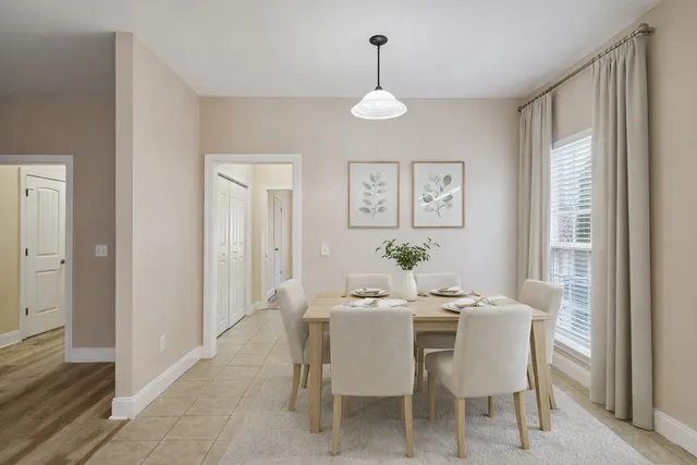 a dining room with furniture a chandelier and wooden floor