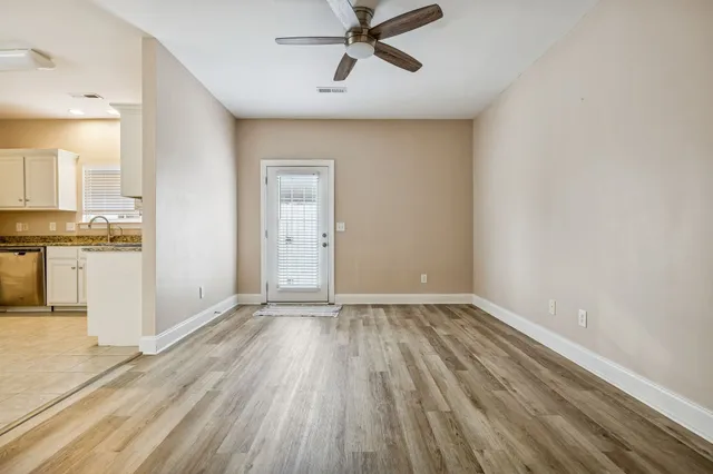 wooden floor in an empty room with a window