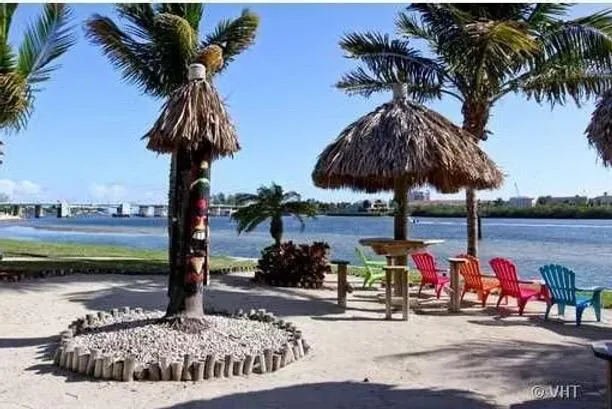 a view of a lake with a table under an umbrella