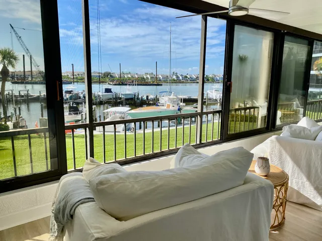 a bed sitting in a balcony next to a tall window