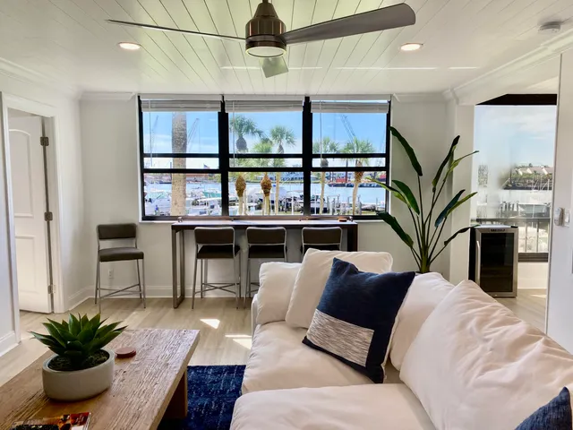 a living room with furniture a fireplace and a potted plant
