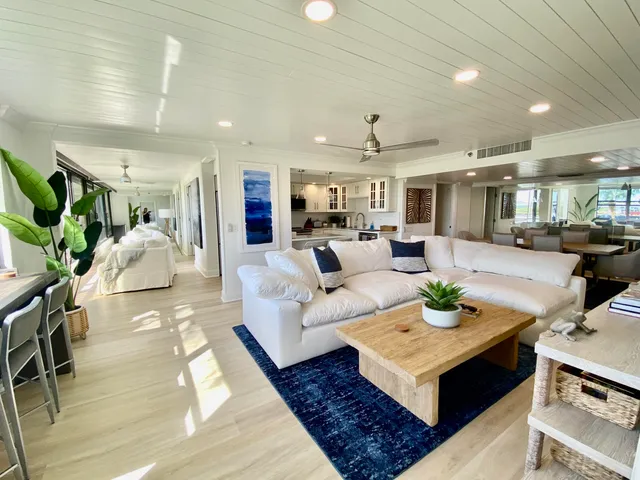 a living room with furniture and kitchen view