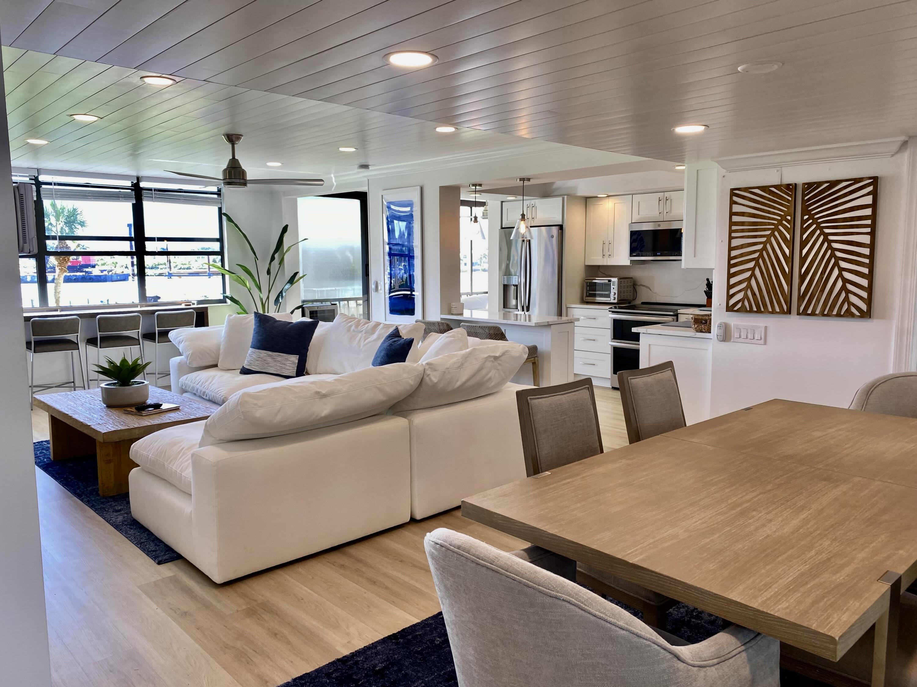 1648 Jupiter Cove Drive, Unit 210 Jupiter, FL 33469 - Photo 7 of 15 a living room with furniture kitchen view and a large window