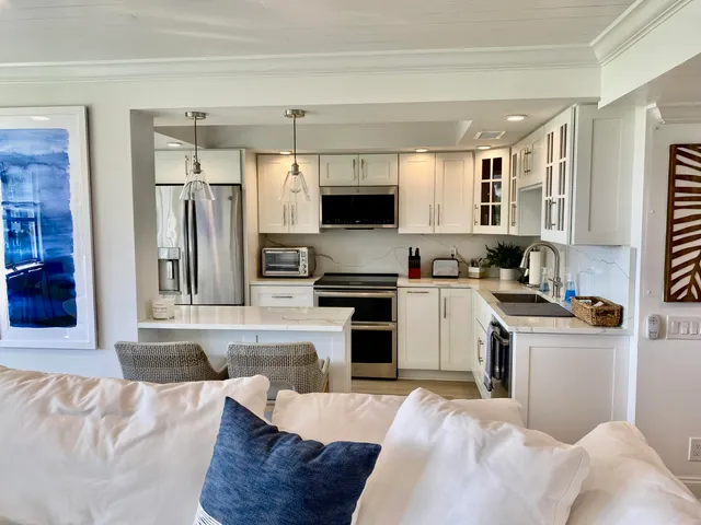 a kitchen with a refrigerator stove and sink