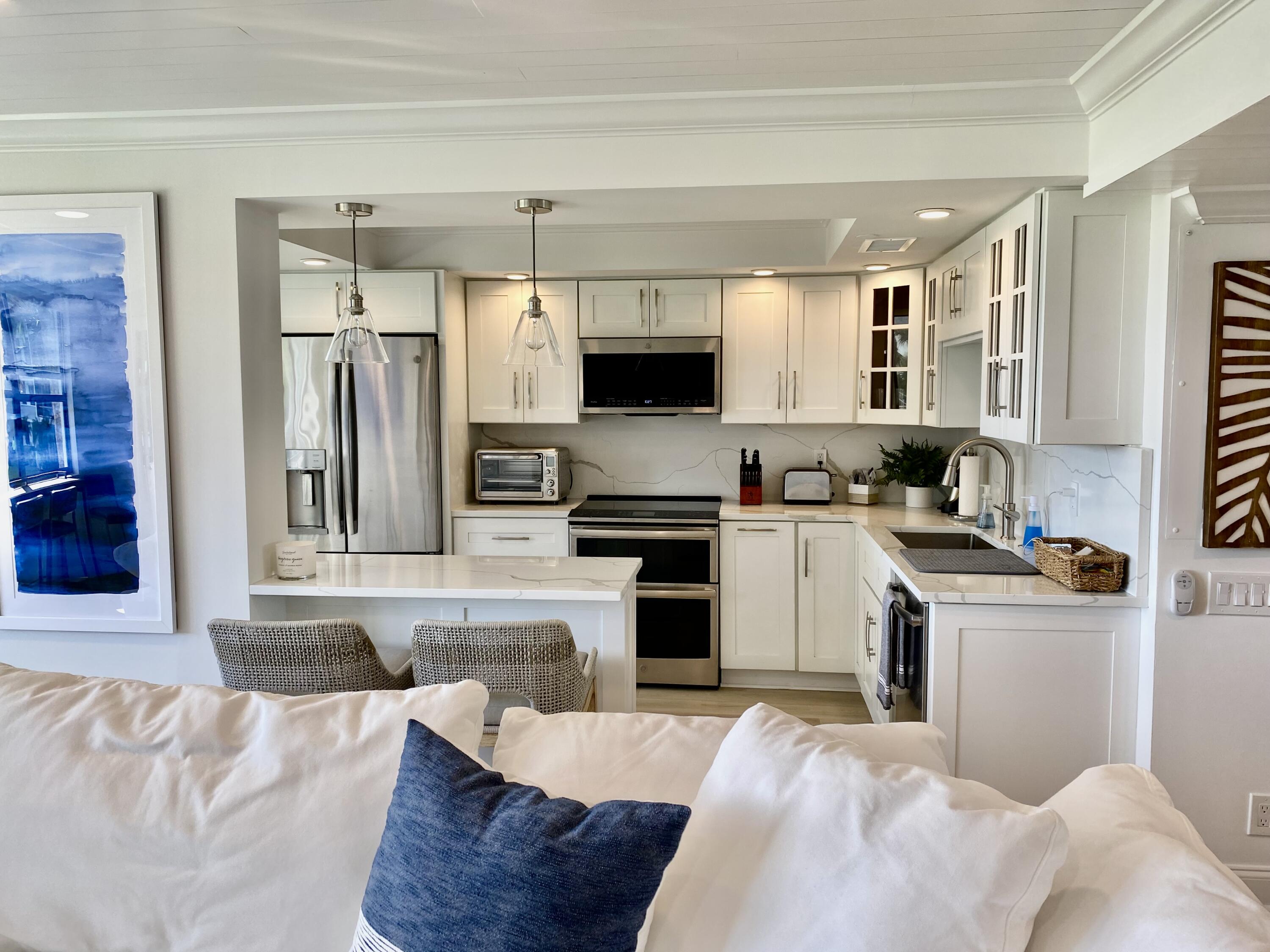 1648 Jupiter Cove Drive, Unit 210 Jupiter, FL 33469 - Photo 9 of 15 a kitchen with a refrigerator stove and sink