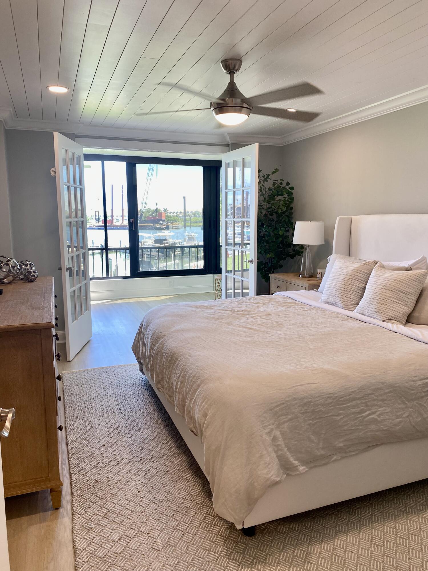 1648 Jupiter Cove Drive, Unit 210 Jupiter, FL 33469 - Photo 10 of 15 a spacious bedroom with a large bed and a large window