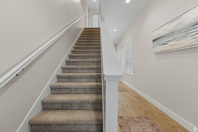 839 Walker Way St. George, UT 84770 - Photo 22 of 32 Carpeted staircase with white handrail and balustrade