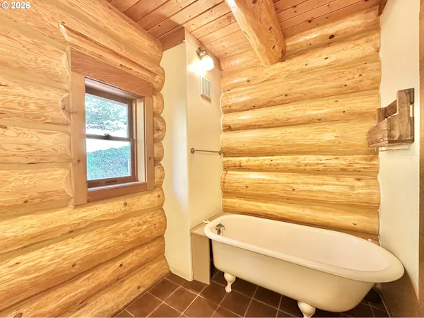 a bathroom with a toilet and a bathtub