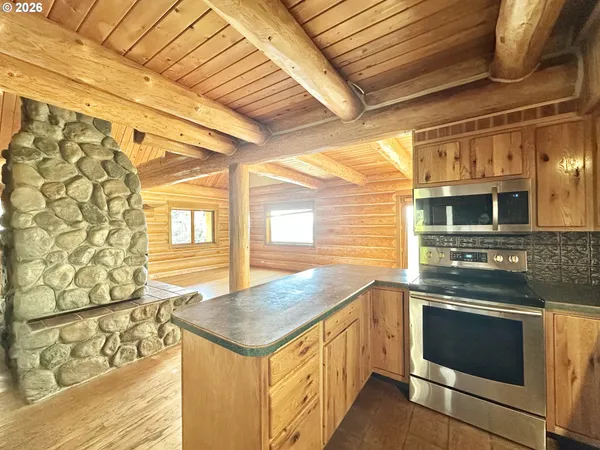 a kitchen that has a stove and a microwave