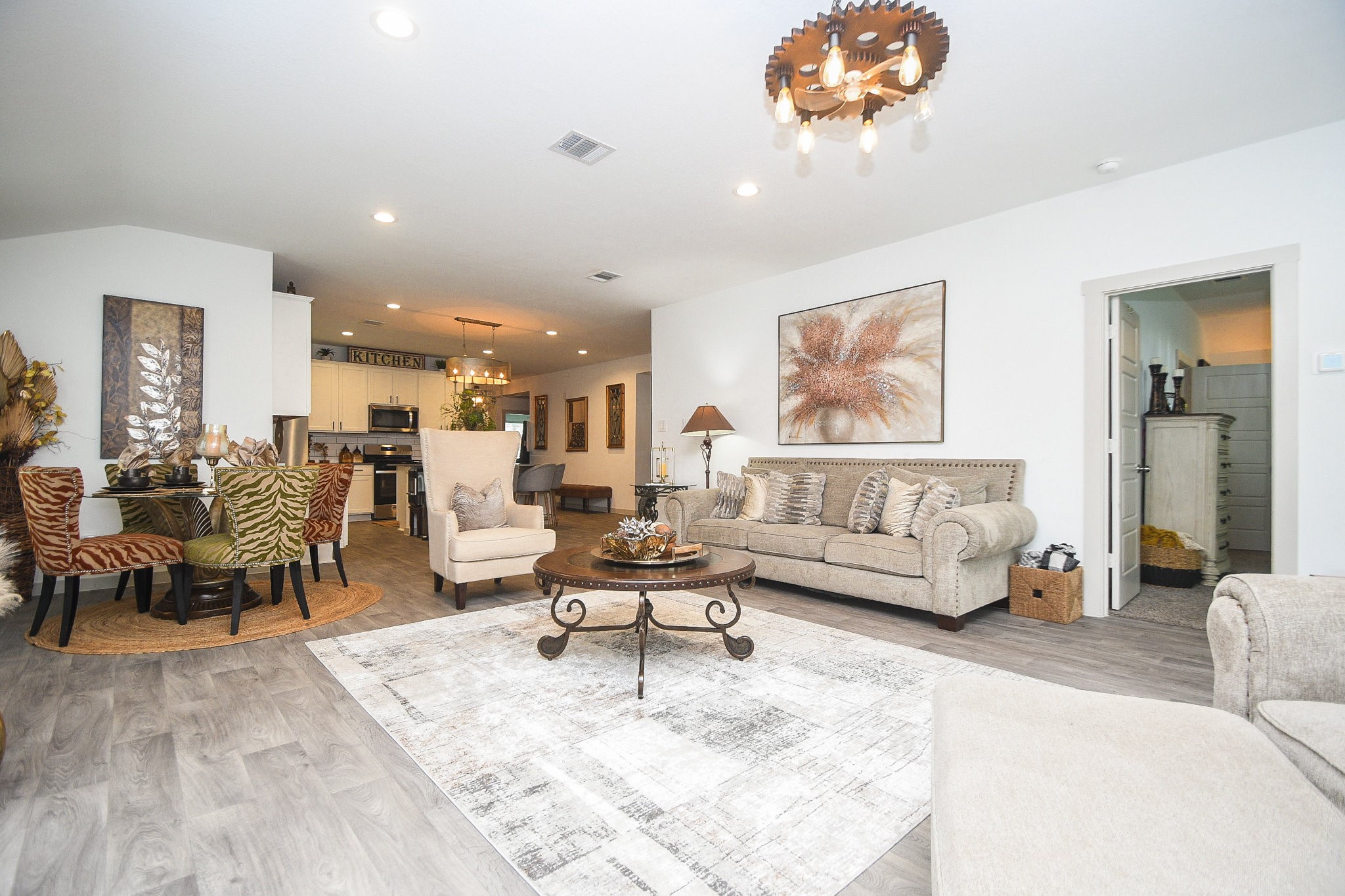 7723 Golden Rubia Lane Rosharon, TX 77583 - Photo 34 of 34 a living room with furniture and a dining table with wooden floor