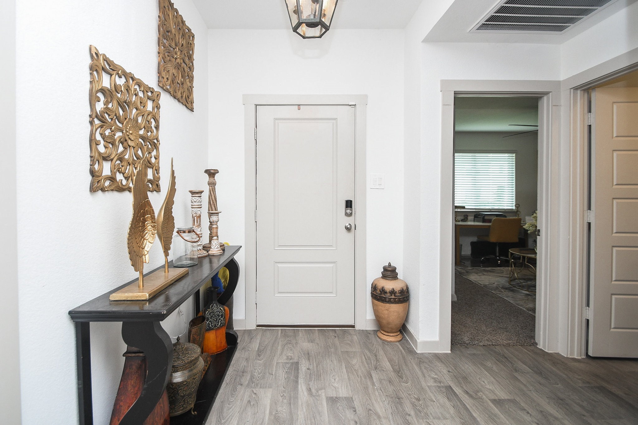 7723 Golden Rubia Lane Rosharon, TX 77583 - Photo 3 of 34 The inviting entry showcases durable vinyl plank flooring and fresh, light-filled interiors throughout the home.