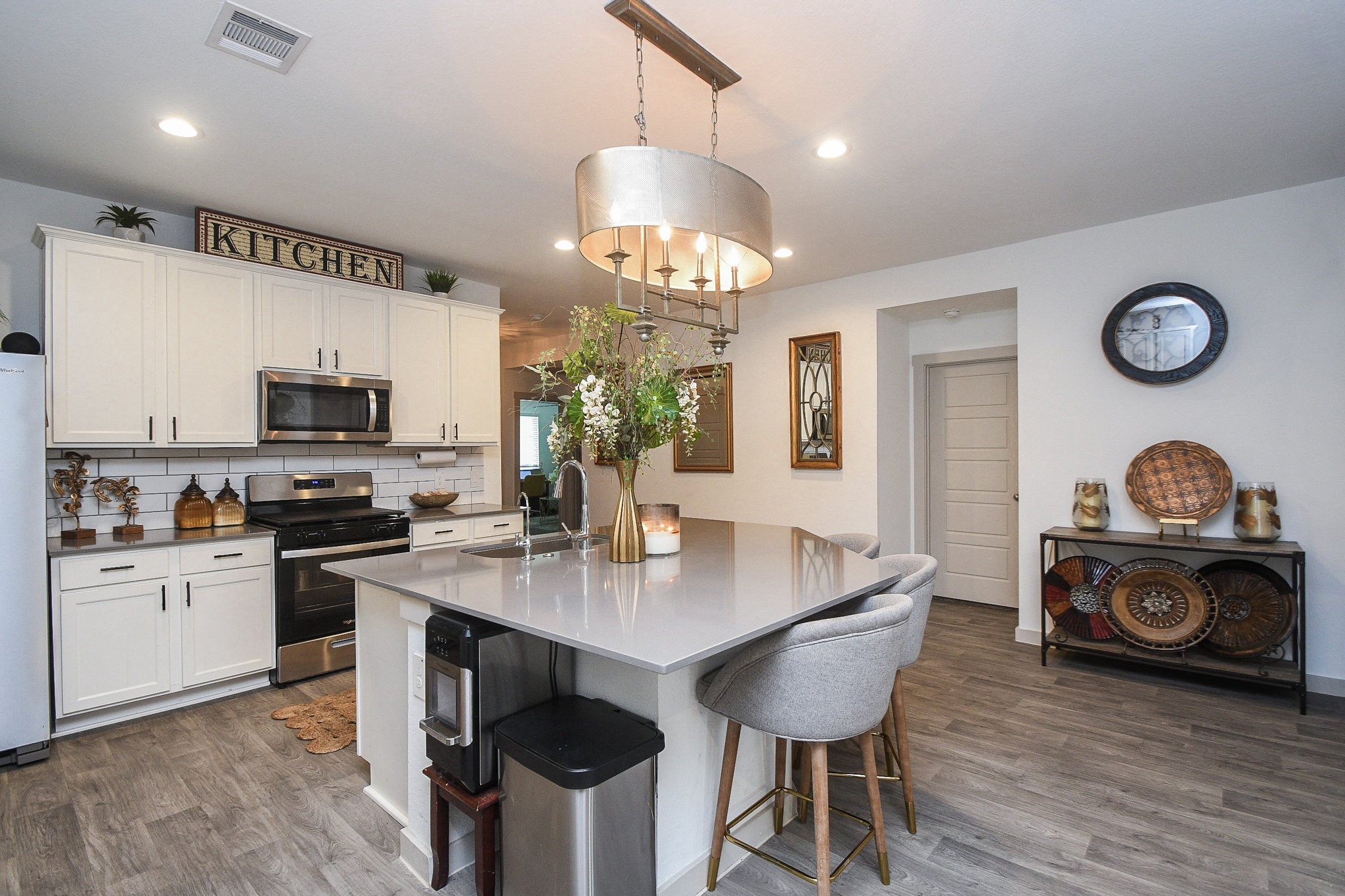7723 Golden Rubia Lane Rosharon, TX 77583 - Photo 7 of 34 a kitchen with a table chairs stove and microwave
