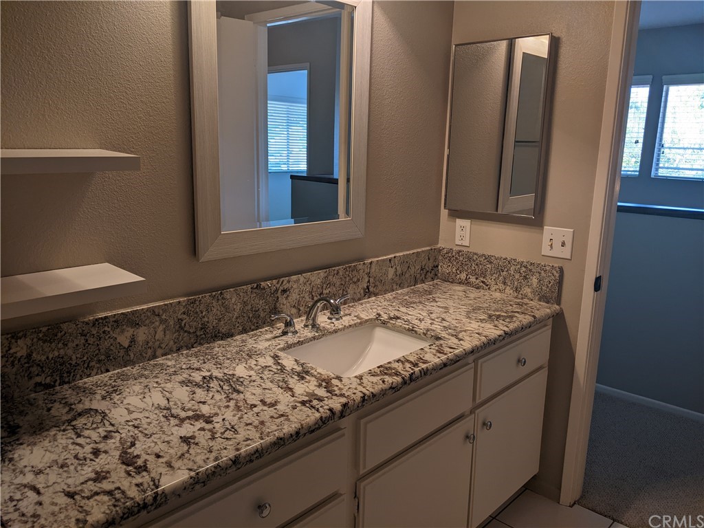 633 North Buttonbush Trail Orange, CA 92869 - Photo 20 of 26 a bathroom with a granite countertop sink and a mirror