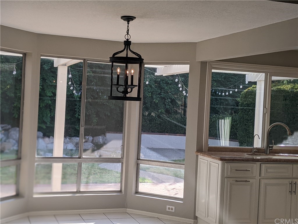 633 North Buttonbush Trail Orange, CA 92869 - Photo 3 of 26 a view of a center island with windows and a chandelier
