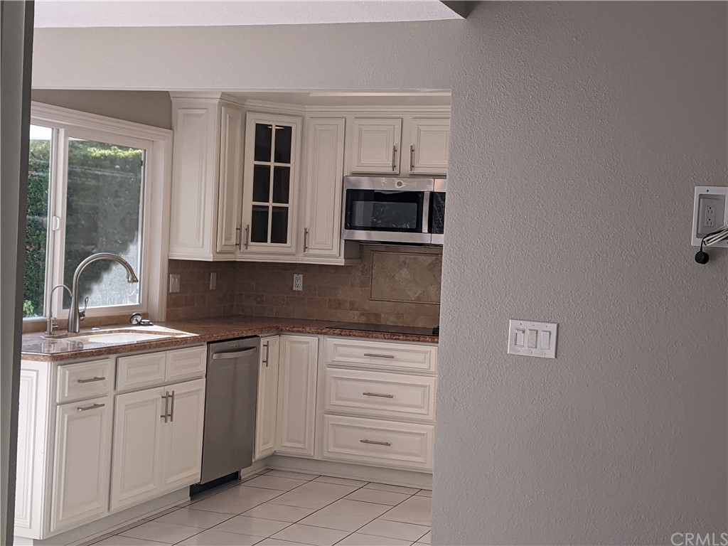 633 North Buttonbush Trail Orange, CA 92869 - Photo 4 of 26 a kitchen with cabinets appliances and a sink