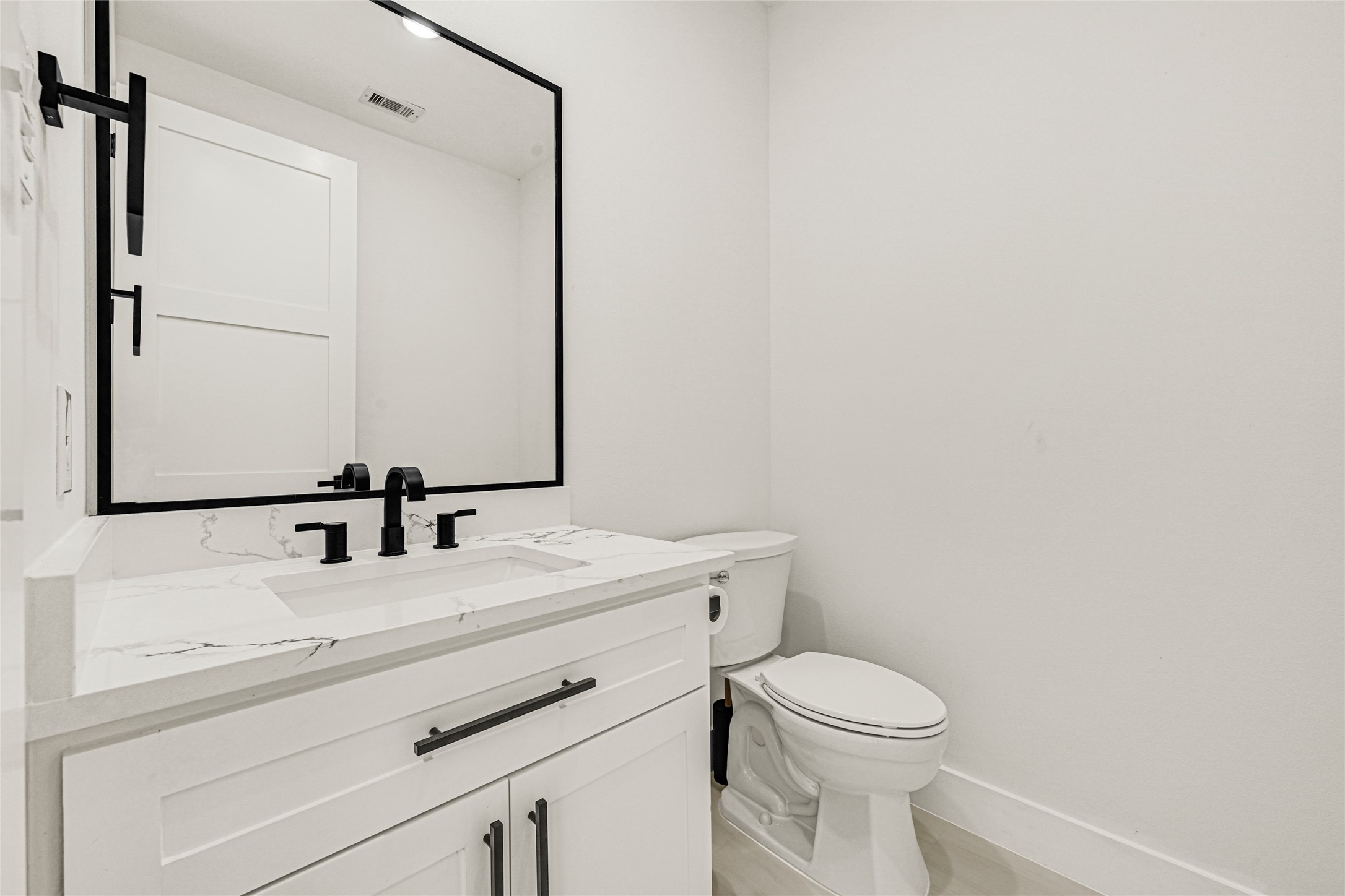 16915 Hamill Drive Rosharon, TX 77583 - Photo 29 of 47 a bathroom with a toilet sink and mirror