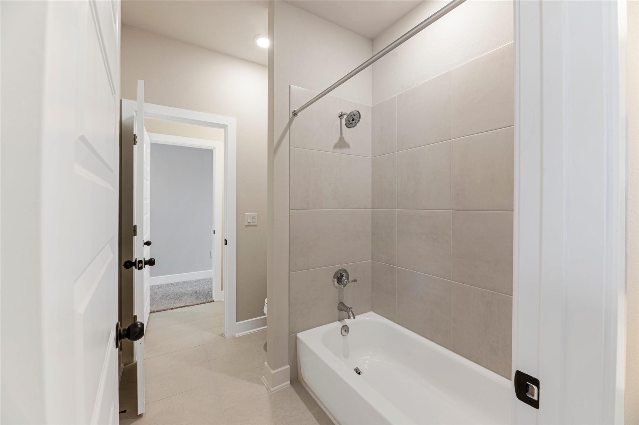 1508 Rodeo Ridge Drive Georgetown, TX 78628 - Photo 25 of 37 Bathroom featuring bathing tub / shower combination and light tile patterned floors