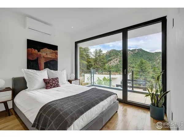 a bedroom with a large bed and a large window