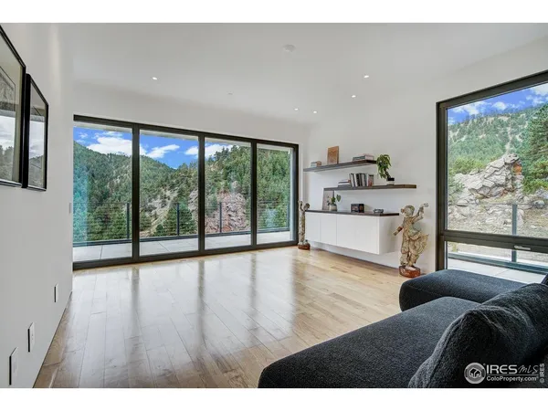 a living room with furniture and large windows