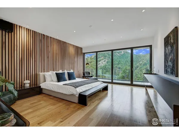 a spacious bedroom with a large bed and a large window