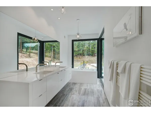 a kitchen with stainless steel appliances a sink window and cabinets