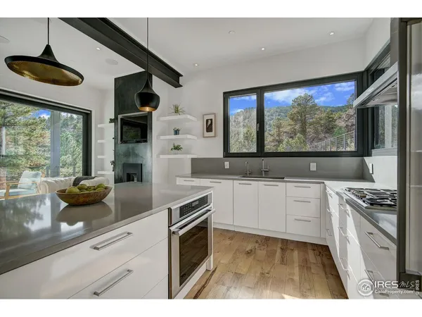 a kitchen with a sink a stove and cabinets