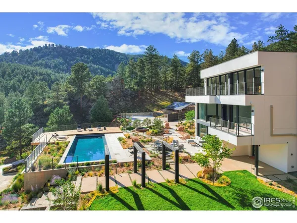 a view of house with yard entertaining space and mountain view