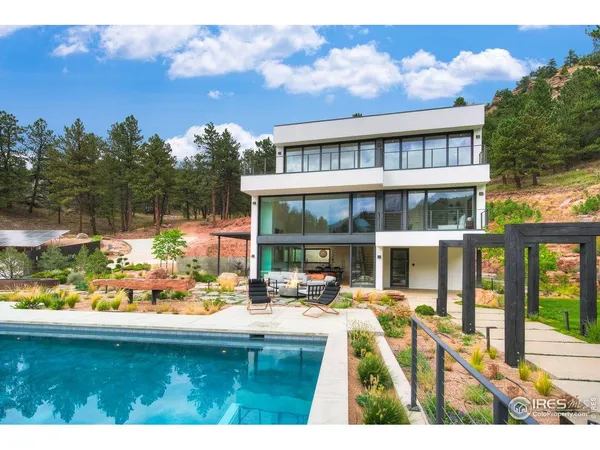 a view of swimming pool with outdoor seating and a garden