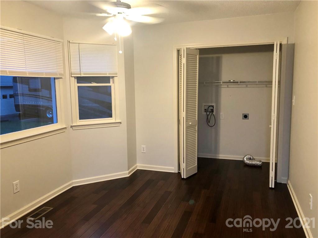 980 Coventry Road Kannapolis, NC 28081 - Photo 14 of 32 an empty room with wooden floor cabinet and windows