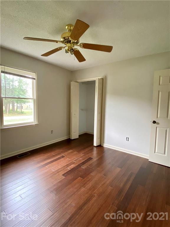 980 Coventry Road Kannapolis, NC 28081 - Photo 22 of 32 a view of an empty room with wooden floor and a window