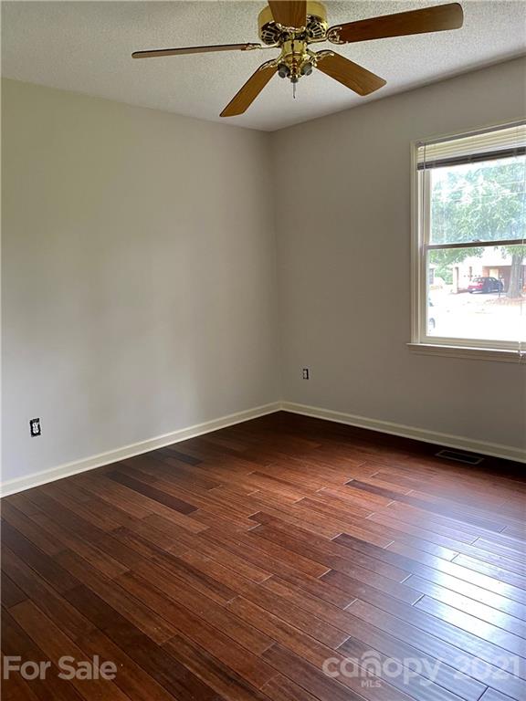 980 Coventry Road Kannapolis, NC 28081 - Photo 23 of 32 an empty room with wooden floor fan and windows