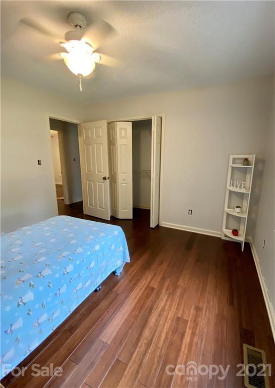 980 Coventry Road Kannapolis, NC 28081 - Photo 27 of 32 a bedroom with a bed and a chandelier