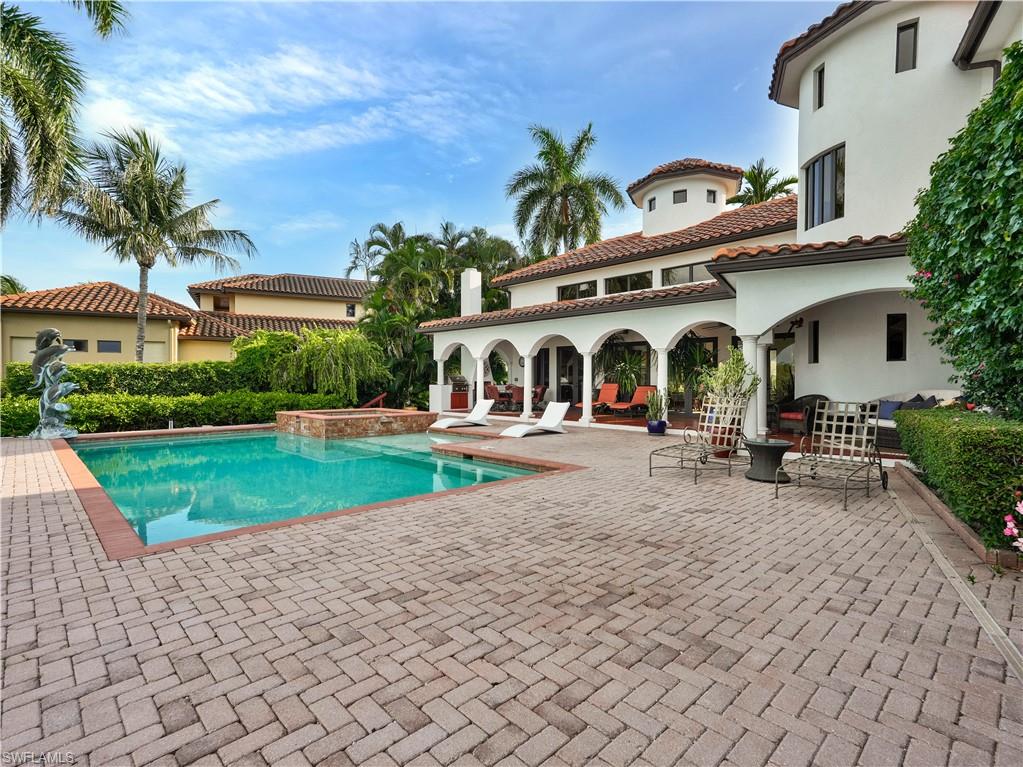 2535 Tarpon Road Naples, FL 34102 - Photo 43 of 50 Mediterranean-style residence featuring a terracotta tile roof, multiple balconies with dark railings, and a prominent tower